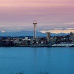 Stunning view of Seattle skyline featuring the Space Needle during sunset over the waterfront.